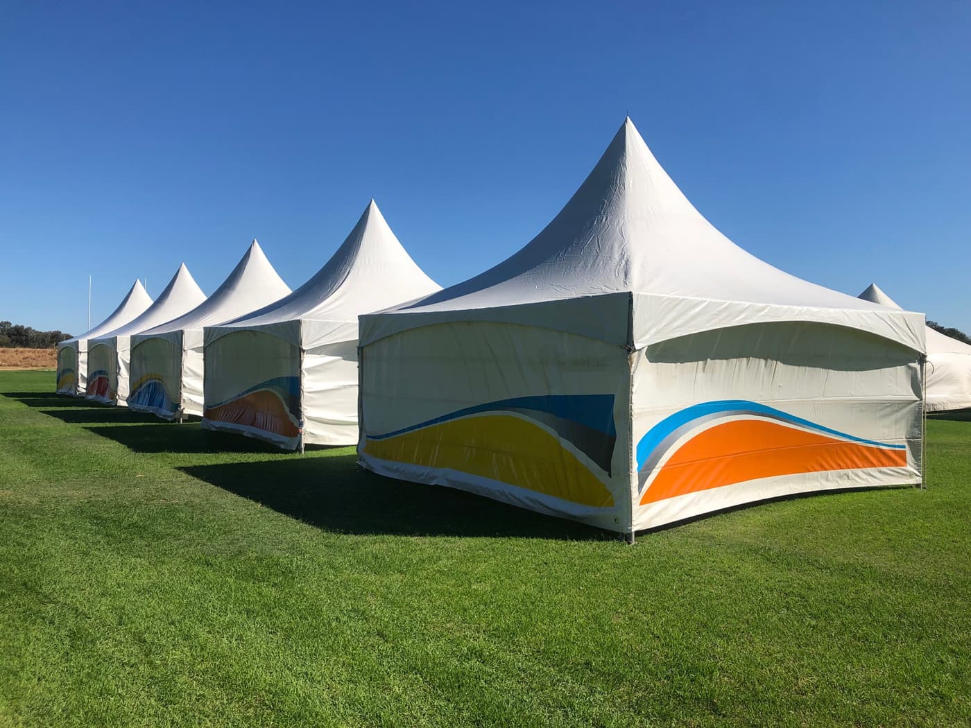 A photo of a row of marquees that have pointed tops.