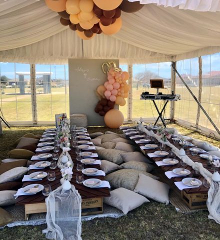 A photo of a wedding event underneath a marquee setup.